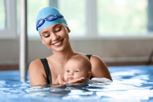 Female Coach And Adorable Baby In Swimming Pool