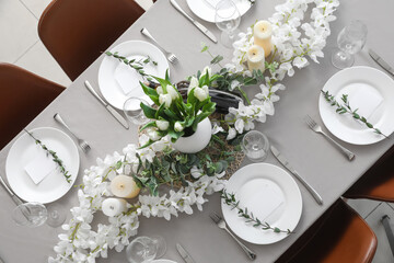 Dining table with beautiful setting, flowers and blank cards