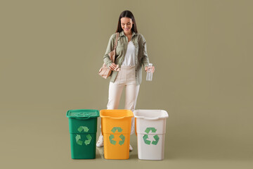 Wall Mural - Young woman sorting plastic bottle and paper on color background