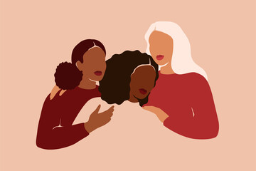 three women of different ethnicities and cultures hug. strong and brave girls support each other and