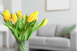 Vase with tulips in living room, closeup