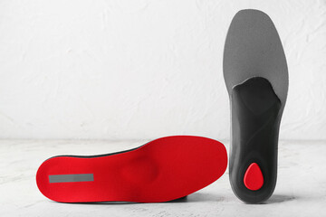 Orthopedic insoles on light background