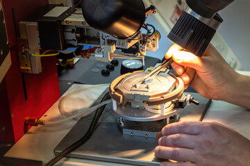 Poster - Production of microelectronics. Examining printed circuit board under microscope. Creation microprocessor. Human hands with tweezers. Creation of modern microprocessor. Manual testing of microchips.