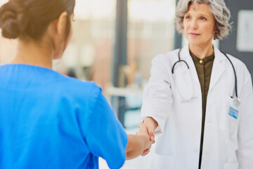 Poster - Partnering up for the protection and preservation of your health. Shot of a doctor and nurse shaking hands.