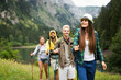 Group of young friends hiking in countryside. Multiracial happy people travelling
