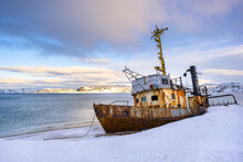 Sea And Abandoned Old Ship, Boat In The Snow. Winter Landscape In Russia, Kola Peninsula, Teriberka