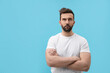 © New Africa - Portrait of handsome man on light blue background, space for text