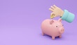 © Kwanchanok - 3D Rendering of hand putting money coin in piggy bank with copy space  on background concept of money savings. 3D Render illustration.