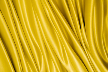 Wall Mural - Beautiful elegant wavy yellow satin silk luxury cloth fabric with monochrome background design. Copy space