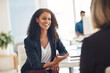 © Daniel Laflor/peopleimages.com - Quick catch up with a coworker. Shot of two young women having a conversation in a modern office.