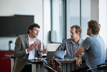 Poster - so heres my idea.... cropped shot of three businessman discussing work in the office.