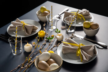 Wall Mural - easter, holidays, tradition and object concept - close up of dinner party table serving over black background