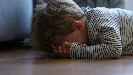 Wall Mural - Child crying on floor having tantrum little boy cries