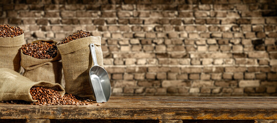 Wall Mural - Fresh coffee beans in sack and dark interior with shadows. 