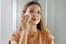 Portrait Of Young Woman Using Cotton Eco Friendly Pads To Remove Make Up