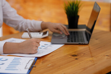 Businesswoman working at office with documents on his desk, doing planning analyzing the financial report, business plan investment, finance analysis concept