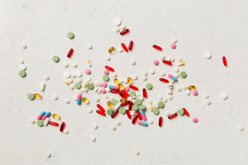 assorted pills and tablets top border over colored background. Many different pills and space for text on colorful background, top view