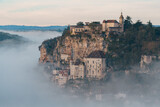Fototapeta  - Rocamadour sunrise, Aerial view of the french village and castle on cliff in early morning with fogs in the Canyon of the Alzou