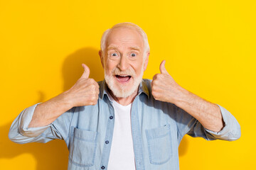 Wall Mural - Portrait of attractive cheerful grey-haired man showing two double thumbup ad cool isolated over bright yellow color background