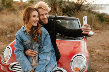 Wall Mural - White mid couple taking selfie on cellphone during trip