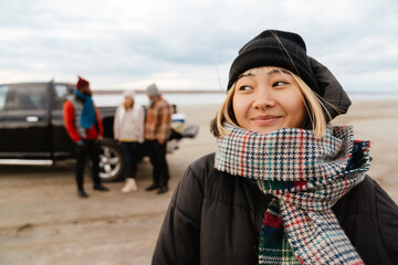 Wall Mural - Asian woman smiling and looking aside during car trip