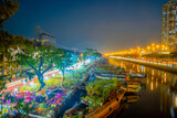 Fototapeta Las - Springtime in Saigon, boat on canal, transport spring flower for Tet to Ben Binh Dong open air market, Vietnamese happy with Lunar New Year, Vietnam