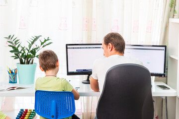 Wall Mural - Father with kid trying to work from home during quarantine. Stay at home, work from home concept during coronavirus