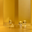Crystal skincare product display stand on gold background decorated with mirror and crystal ball