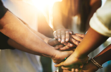 Poster - Team support. Cropped shot of an unrecognizable group of people putting their hands together in unity outside.