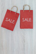 SALE sign on bag: it's time for a shopping spree ,Colorful autumn leaves in colorful paper shopping bags. Sale and shopping concept,Red shopping bag