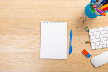 Wall Mural - Working table with keyboard and notepad, pen, pencil and plant in home office. top view