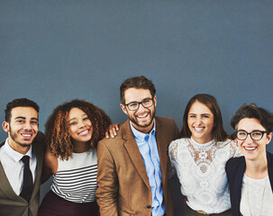 Poster - Were in it together. Studio portrait of a group of businesspeople standing together against a gray background.