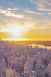 Landscape, sunrise over a snowy forest and lake in Lapland.Colorful sky in the rays of the sun and clouds.