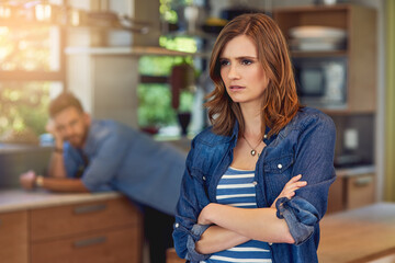 Aufkleber - When poor communication causes conflict. Shot of a young woman looking upset after a fight with her husband who is standing in the background.