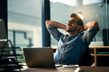 Sticker - When the impossible became possible. Shot of a young businessman taking a break at his desk during a late night at work.