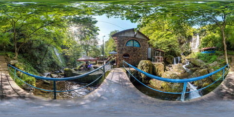 Wall Mural - full seamless 360 hdri panoramaon on metal bridge over fast river in mountains with a lot of tourists in equirectangular spherical projection. VR  AR content