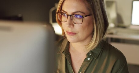 Poster - Focused on making success happen. 4k video of a young businesswoman working late on a computer in an office.