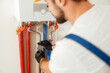 © Kostiantyn - Closeup of plumber working with water pipes while installing heating system in apartment