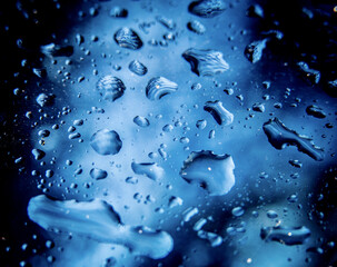 Sticker - A closeup shot of water droplets on a blue surface