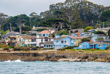 Houses In Pacific Grove, California (in Monterey County) Overlook The Rocky Coastline, As Viewed From A Passing Boat.