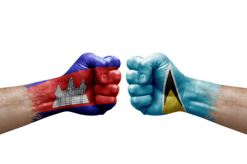 Two hands punch to each others on white background. Country flags painted fists, conflict crisis concept between cambodia and saint lucia