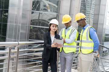 Group of Engineer Worker Wearing Safety Uniform and Hard Hat Uses Tablet Computer. Happy Successful. working with tablet checklist