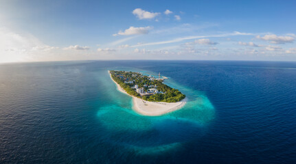 Wall Mural - Tropical island with white beach and turquoise water in Maldives. Idyllic summer holidays vacation destination. Luxury hotel resort. Warm sunny day with blue sky. Aerial drone panorama.