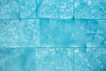 Ice block wall as texture or background. Cold frost transparent bricks pattern