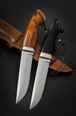 Hunting knife handmade on a black background.