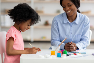 Wall Mural - Cute african american little girl drawing at daycare