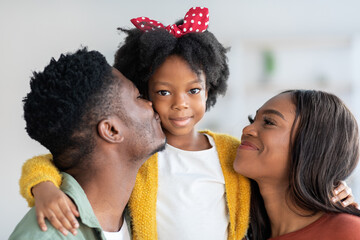 Wall Mural - Portrait Of Happy Black Family, Young Parents And Cute Little Daughter