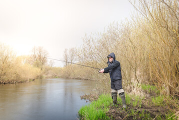 Wall Mural - Fishing on the river bank.