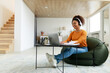 © Prostock-studio - Portrait of smiling black woman using laptop at home