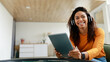 © Prostock-studio - Portrait of smiling black woman using tablet at home
